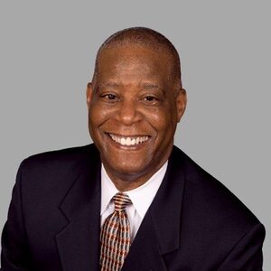 Close up image of Gary E. Horton smiling and wearing black suit jacket with white dress shirt and tie.